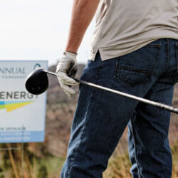 man carrying golf club