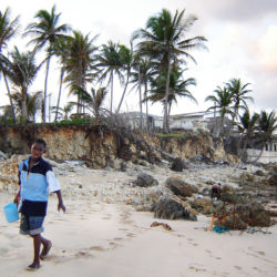 Children search for treasures along eroded beaches in Long Bay, Jamaica. jamaica beach