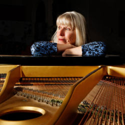 Jazz pianist Deb Barr with her piano in Montrose, Colorado. pianist with her grand piano