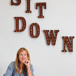 woman with words sit down
