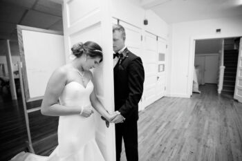 bride and groom have first look with door between them